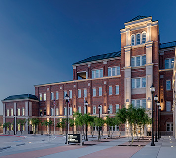 Image of a multi-story brick building used for public offices.